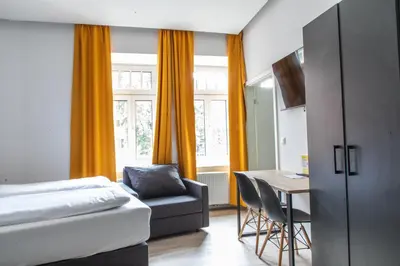 Ein Bett oder Betten in einem Zimmer der Unterkunft Servus Apartments by Homaris