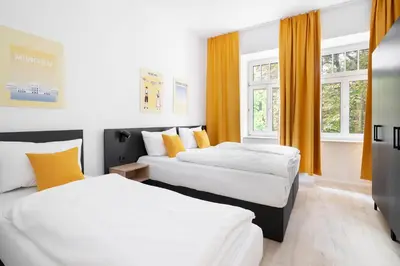 Ein Bett oder Betten in einem Zimmer der Unterkunft Servus Apartments by Homaris