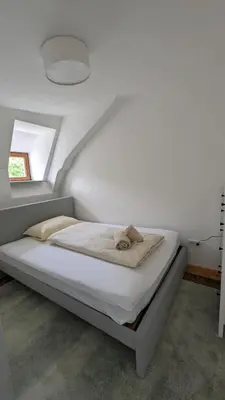 Ein Bett oder Betten in einem Zimmer der Unterkunft LIBORIA I Als Gruppe im Denkmal Augsburgs