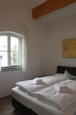 Ein Bett oder Betten in einem Zimmer der Unterkunft meywohnen Stadthaus Bad Aibling