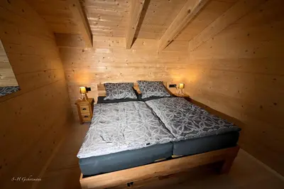 Ein Bett oder Betten in einem Zimmer der Unterkunft Holzwies Chalets