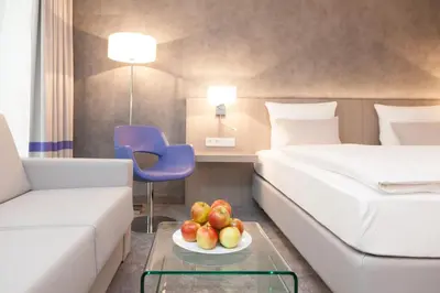 Ein Bett oder Betten in einem Zimmer der Unterkunft relexa hotel München