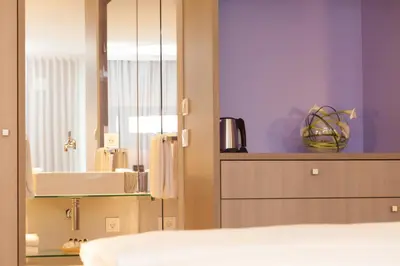 Ein Bett oder Betten in einem Zimmer der Unterkunft relexa hotel München