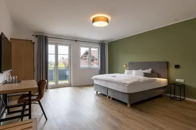 Ein Bett oder Betten in einem Zimmer der Unterkunft Hotel Baumann