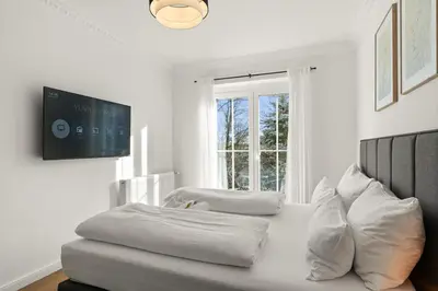 Ein Bett oder Betten in einem Zimmer der Unterkunft YUVA HOMES am Kurpark - BRIGHT Collection