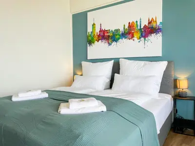 Ein Bett oder Betten in einem Zimmer der Unterkunft UNiQE - SKY-TV - 23 OG - Stadtblick - Kongress