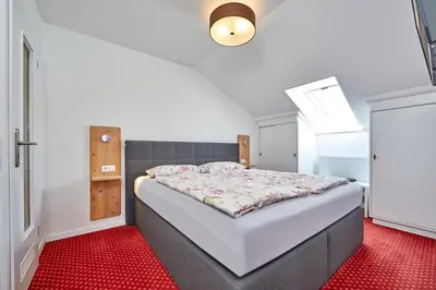 Ein Bett oder Betten in einem Zimmer der Unterkunft Alpen Gästehaus