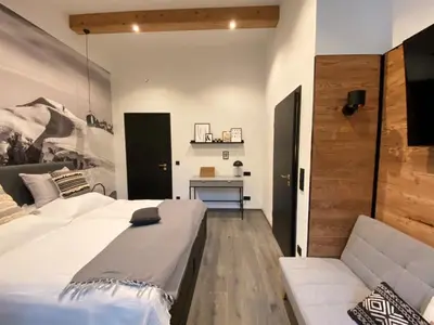 Ein Bett oder Betten in einem Zimmer der Unterkunft ciao-aschau Haus zur Burg FeWo Bergfest Ap110