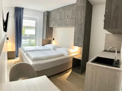 Ein Bett oder Betten in einem Zimmer der Unterkunft Apartimo München-Unterhaching