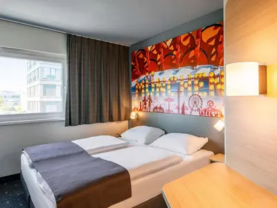 Ein Bett oder Betten in einem Zimmer der Unterkunft B&B Hotel München City-West