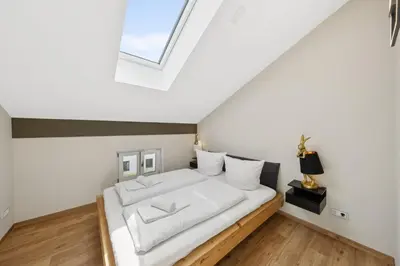 Ein Bett oder Betten in einem Zimmer der Unterkunft Vaicun Stays - Stilvolle Apartments am Tegernsee