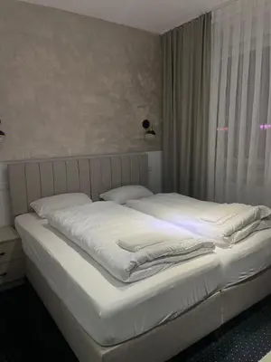 Ein Bett oder Betten in einem Zimmer der Unterkunft Gastpark Hotel