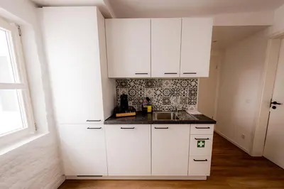 Küche/Küchenzeile in der Unterkunft Highlight am Stadtplatz Mühldorf - C4S COME4STAY - 2 Zimmer Wohnung I bis zu 5 Gäste