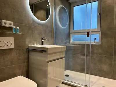 Ein Badezimmer in der Unterkunft Chiemgau Comfort A3 Ferienwohnanlage Oberaudorf mit Hallenbad