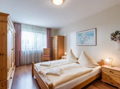 Ein Bett oder Betten in einem Zimmer der Unterkunft Chiemgau-Comfort B2 Ferienwohnanlage Oberaudorf mit Indoor Pool und Sauna