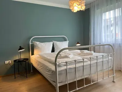 Ein Bett oder Betten in einem Zimmer der Unterkunft Chiemgau Comfort F4 Ferienwohnanlage Oberaudorf mit Hallenbad und Sauna