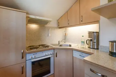 Küche/Küchenzeile in der Unterkunft Chiemgau Comfort B7 Ferienwohnanlage Oberaudorf mit Indoor Pool und Sauna