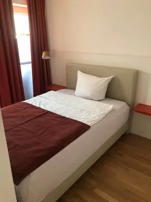 Ein Bett oder Betten in einem Zimmer der Unterkunft Baumann Suiten