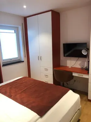 Ein Bett oder Betten in einem Zimmer der Unterkunft Baumann Suiten