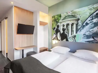 Ein Bett oder Betten in einem Zimmer der Unterkunft B&B Hotel München-Trudering