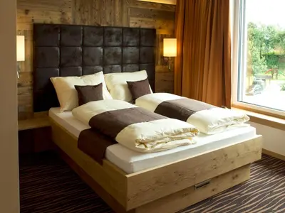 Ein Bett oder Betten in einem Zimmer der Unterkunft Alpenflair Hotel