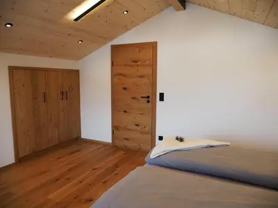 Ein Bett oder Betten in einem Zimmer der Unterkunft Ferienwohnungen Alpinum