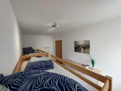 Ein Bett oder Betten in einem Zimmer der Unterkunft FeWo Ruhepo(o)l inkl. Sauna