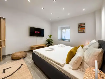 Ein Bett oder Betten in einem Zimmer der Unterkunft Modern und Gemütlich Augsburg Center Kongress