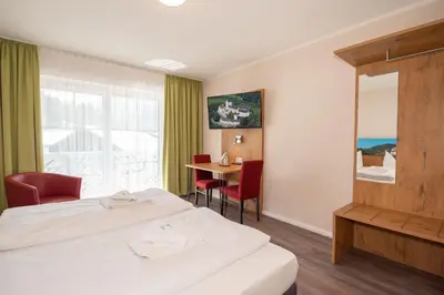 Ein Bett oder Betten in einem Zimmer der Unterkunft Burghotel Aschau