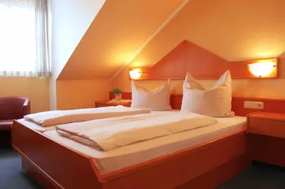 Ein Bett oder Betten in einem Zimmer der Unterkunft Burghotel Aschau