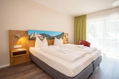 Ein Bett oder Betten in einem Zimmer der Unterkunft Burghotel Aschau