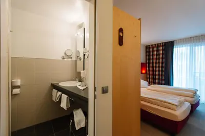 Ein Bett oder Betten in einem Zimmer der Unterkunft Landhotel Gasthof Drexler GbR