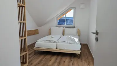 Ein Bett oder Betten in einem Zimmer der Unterkunft LiBORIA I Als Gruppe am Riegsee