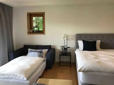 Ein Bett oder Betten in einem Zimmer der Unterkunft Haus Hochland - Moderne Alpenwohnung Garten&Natur