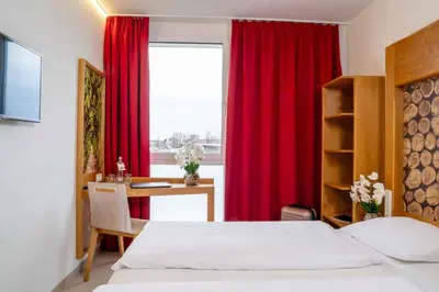 Ein Bett oder Betten in einem Zimmer der Unterkunft PLAZA INN Dachau - München