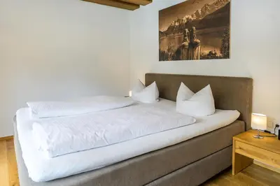 Ein Bett oder Betten in einem Zimmer der Unterkunft Alpencharme