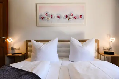 Ein Bett oder Betten in einem Zimmer der Unterkunft Alpen-Residence