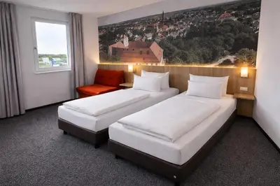 Ein Bett oder Betten in einem Zimmer der Unterkunft Euro Hotel Friedberg