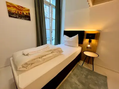Ein Bett oder Betten in einem Zimmer der Unterkunft Adlzreiter City Pension