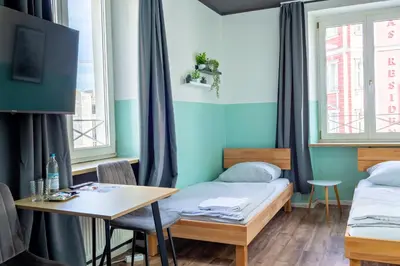 Ein Bett oder Betten in einem Zimmer der Unterkunft Schwanthaler Hof