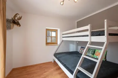 Ein Bett oder Betten in einem Zimmer der Unterkunft Grabner Riedleiten Berghütte Wildbarren