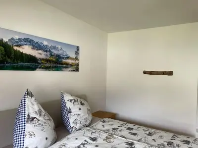 Ein Bett oder Betten in einem Zimmer der Unterkunft Ferienhaus Partenkirchen