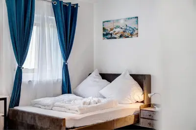 Ein Bett oder Betten in einem Zimmer der Unterkunft Alpina Apartment