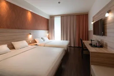 Ein Bett oder Betten in einem Zimmer der Unterkunft Star G Hotel Premium München Domagkstraße