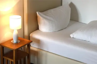 Ein Bett oder Betten in einem Zimmer der Unterkunft Pension Hubertusstuben