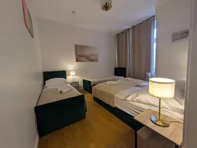 Ein Bett oder Betten in einem Zimmer der Unterkunft Munich Apartment 110 qm with 3 Bedrooms very cetral location 1 to 10 Guests