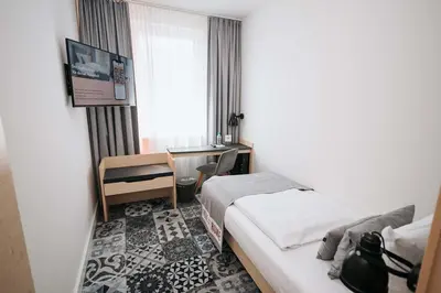 Ein Bett oder Betten in einem Zimmer der Unterkunft Coffee Fellows Hotel München-Freiham