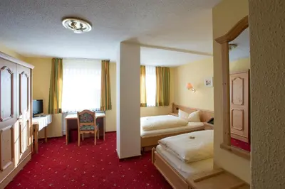 Ein Bett oder Betten in einem Zimmer der Unterkunft Hotel Bauer garni
