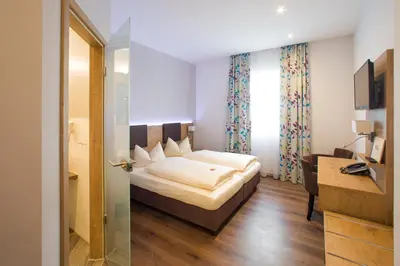 Ein Bett oder Betten in einem Zimmer der Unterkunft Hotel Bauer garni