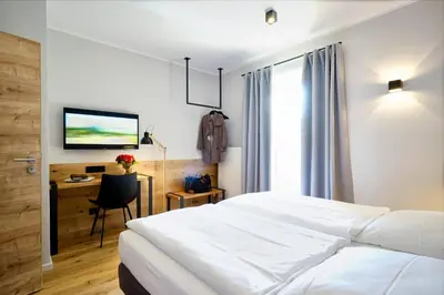 Ein Bett oder Betten in einem Zimmer der Unterkunft Gasthof Neuwirt Unterföhring